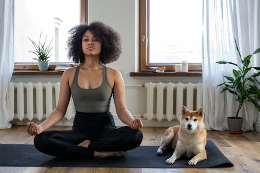 person doing yoga with dog