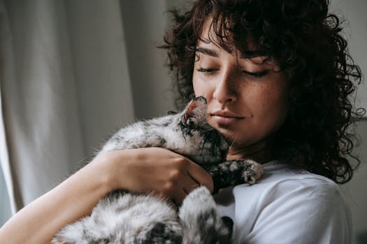 cat cuddling with its owner