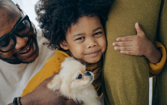 a child cuddling with a puppy